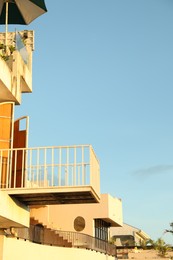 Photo of Beautiful villa with balconies against blue sky. Space for text