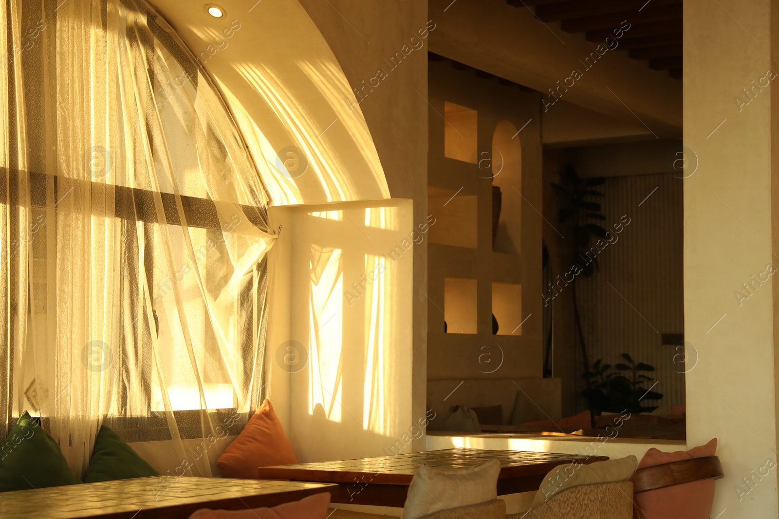 Wooden table and chairs near window indoors Photo of Wooden table and chairs near window indoors