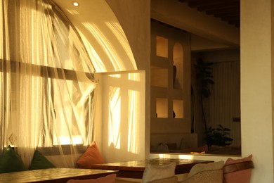 Photo of Wooden table and chairs near window indoors