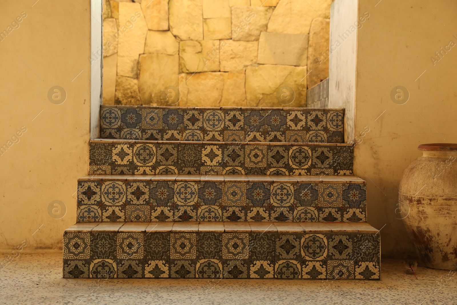 Stairs decorated with beautiful tiles near entrance indoors Photo of Stairs decorated with beautiful tiles near entrance indoors