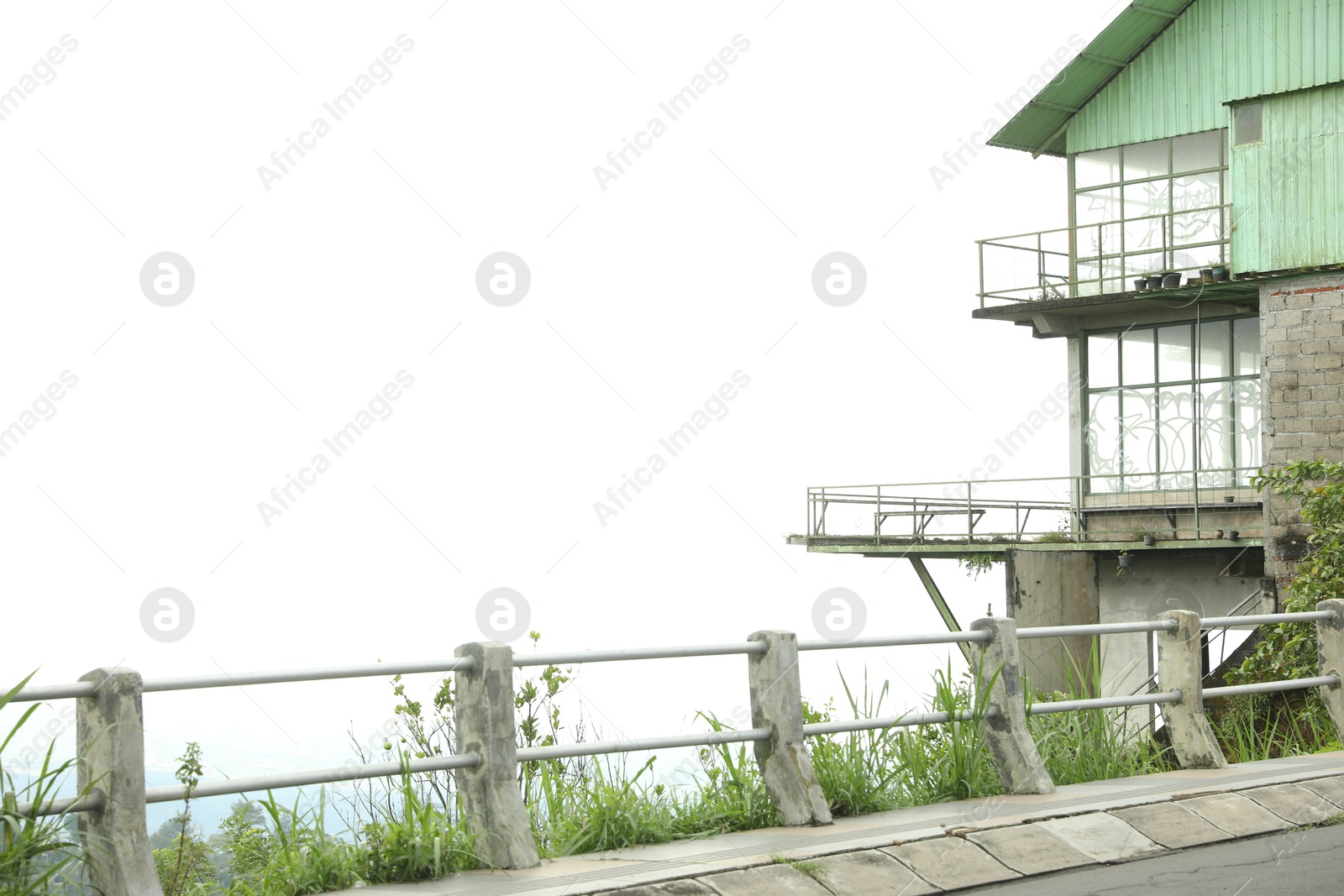 Safety railing along road and old building. Space for text Photo of Safety railing along road and old building. Space for text