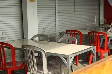 Photo of Empty tables and chairs in outdoor cafe