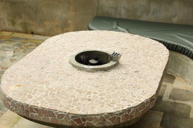 Photo of Stone table with fireplace in backyard, closeup