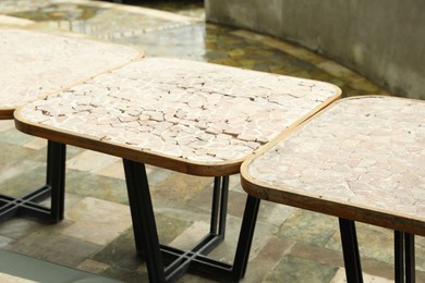 Photo of Empty stylish tables in backyard, closeup view