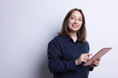 Photo of Woman with modern tablet on white background, space for text