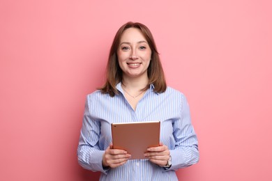 Photo of Woman with modern tablet on pink background