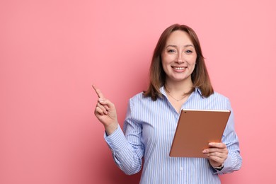 Photo of Woman with modern tablet on pink background, space for text