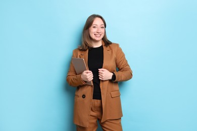 Photo of Woman with modern tablet on light blue background