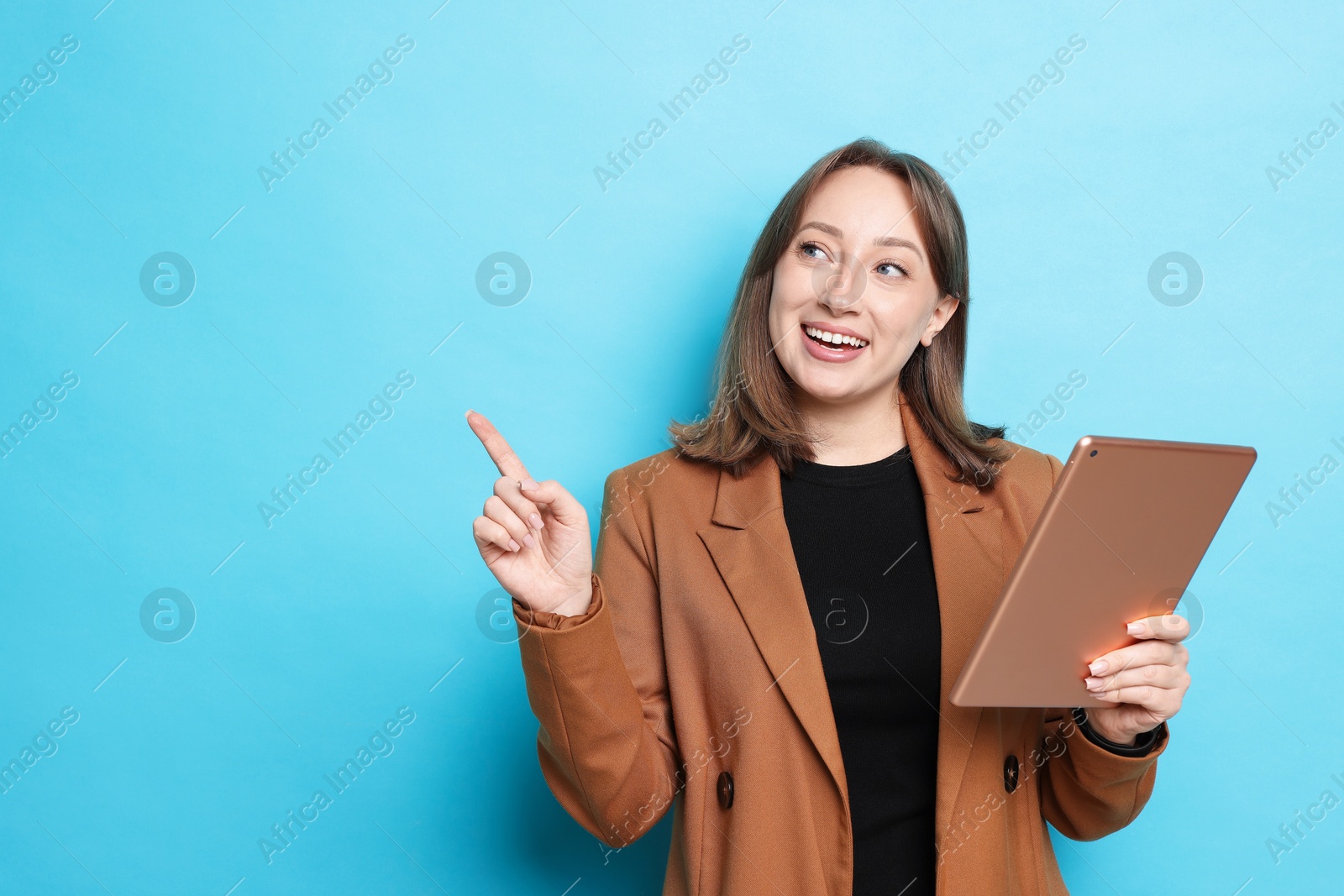 Woman with modern tablet on light blue background, space for text Photo of Woman with modern tablet on light blue background, space for text