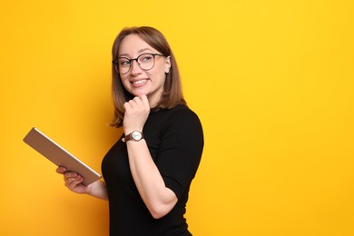 Photo of Woman with modern tablet on orange background, space for text