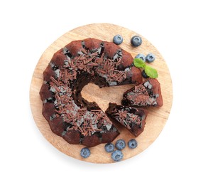 Photo of Delicious bundt cake with blueberries, mint and chocolate shavings isolated on white, top view