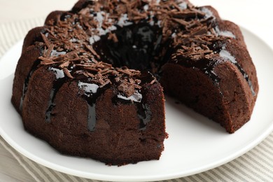Photo of Delicious chocolate bundt cake on table, closeup