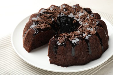 Photo of Delicious chocolate bundt cake on light table, closeup