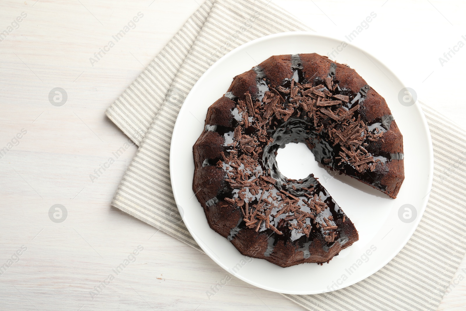 Delicious chocolate bundt cake on light wooden table, top view Photo of Delicious chocolate bundt cake on light wooden table, top view