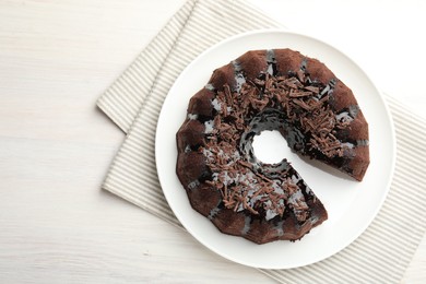 Photo of Delicious chocolate bundt cake on light wooden table, top view
