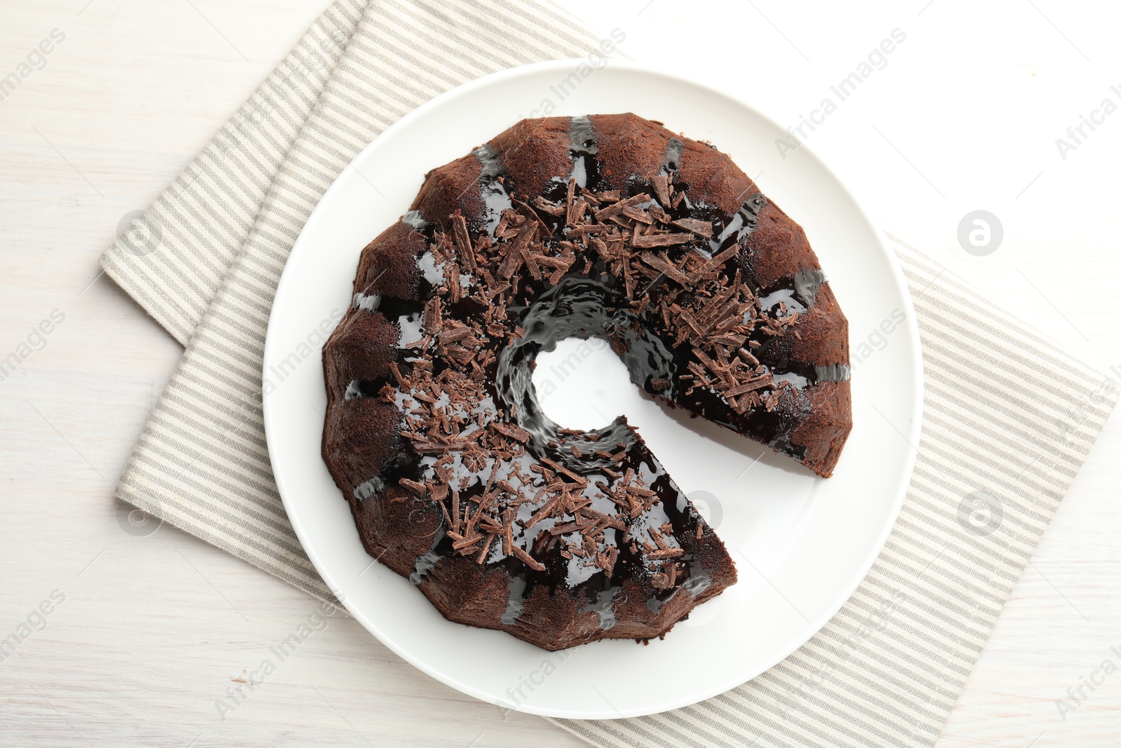 Delicious chocolate bundt cake on light wooden table, top view Photo of Delicious chocolate bundt cake on light wooden table, top view