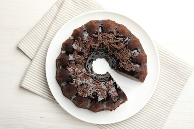 Photo of Delicious chocolate bundt cake on light wooden table, top view