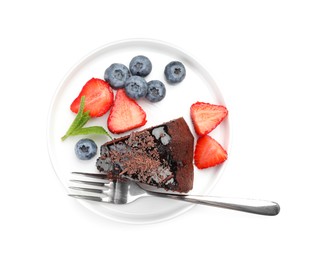 Photo of Piece of delicious chocolate bundt cake with strawberries, mint and blueberries isolated on white, top view