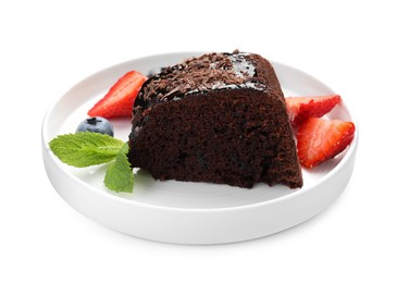 Photo of Piece of delicious chocolate bundt cake with strawberries, mint and blueberry isolated on white