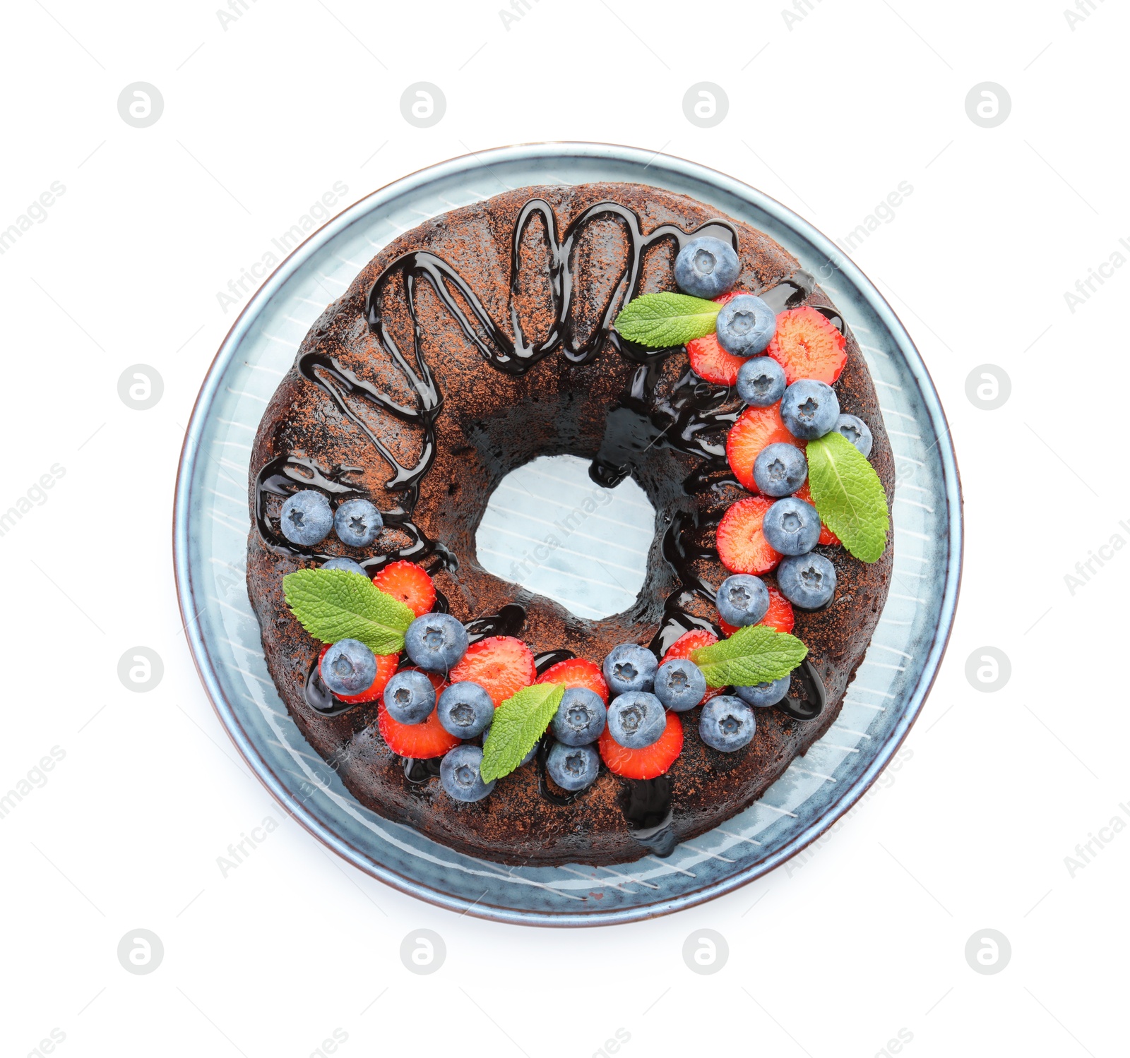 Delicious chocolate bundt cake with strawberries, mint and blueberries isolated on white, top view Photo of Delicious chocolate bundt cake with strawberries, mint and blueberries isolated on white, top view