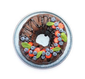 Photo of Delicious chocolate bundt cake with strawberries, mint and blueberries isolated on white, top view