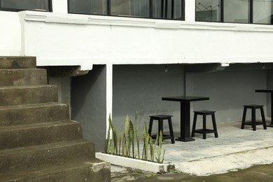 Photo of Empty tables and chairs near building outdoors