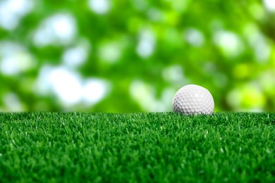 Image of Golf ball on green grass outdoors, closeup