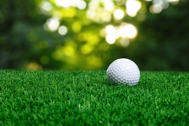 Image of Golf ball on green grass outdoors, closeup