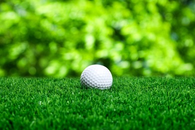 Image of Golf ball on green grass outdoors, closeup