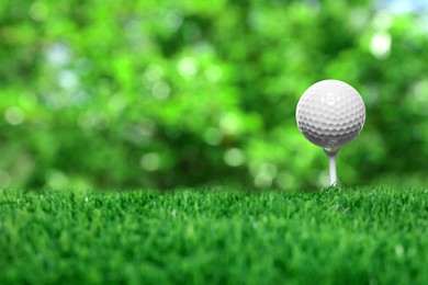 Image of Golf ball on green grass outdoors, closeup