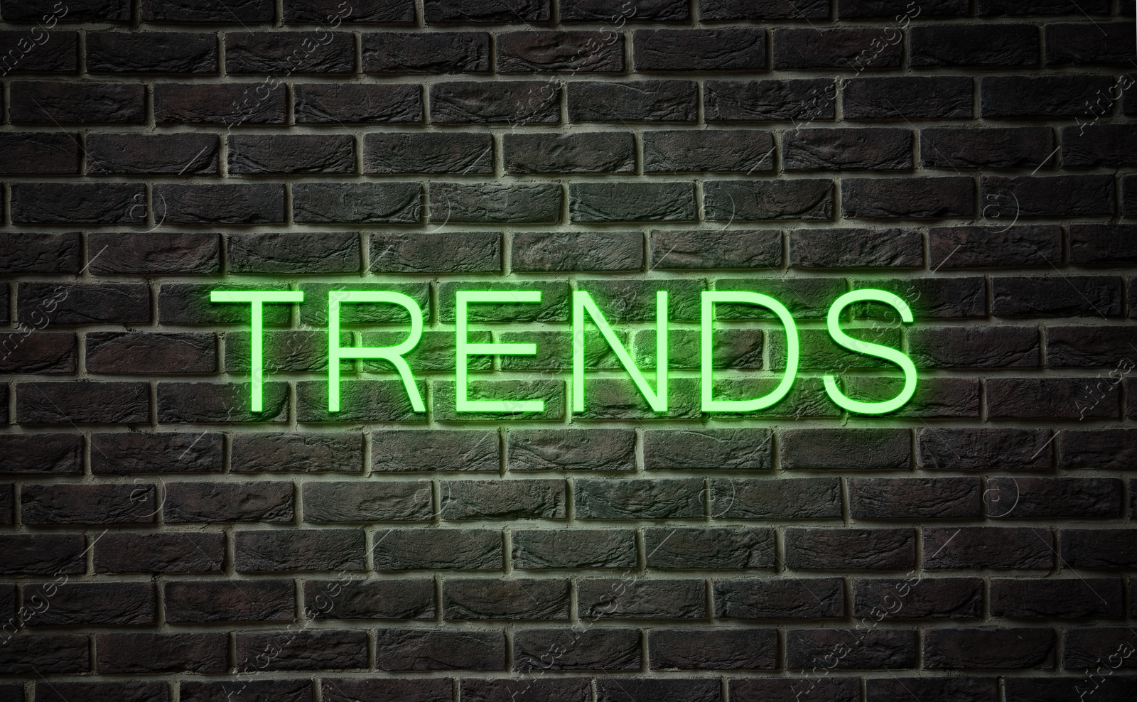 Neon sign with word Trends on black brick wall Image of Neon sign with word Trends on black brick wall