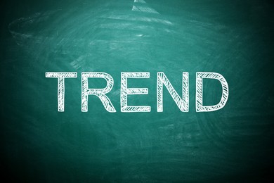 Image of Trend concept. White word on green chalkboard
