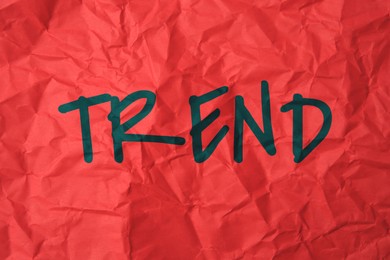 Image of Trend. Word on crumpled red sheet of paper