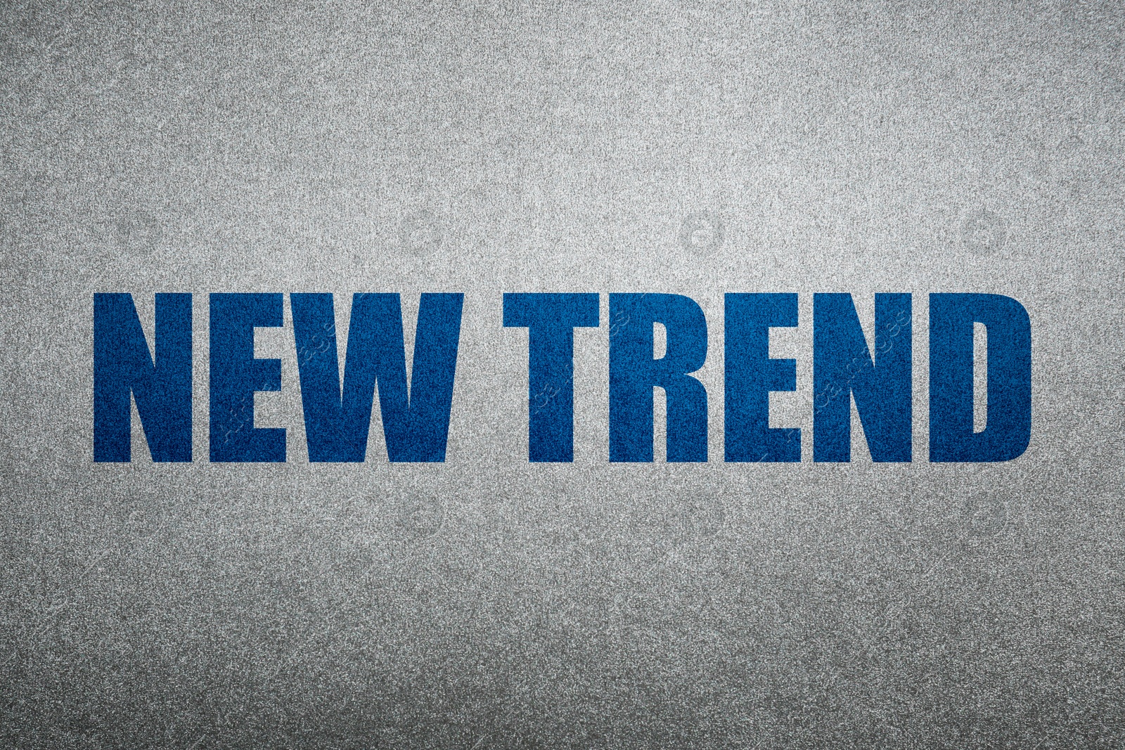New Trend. Blue words on shiny silver background Image of New Trend. Blue words on shiny silver background