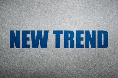 Image of New Trend. Blue words on shiny silver background