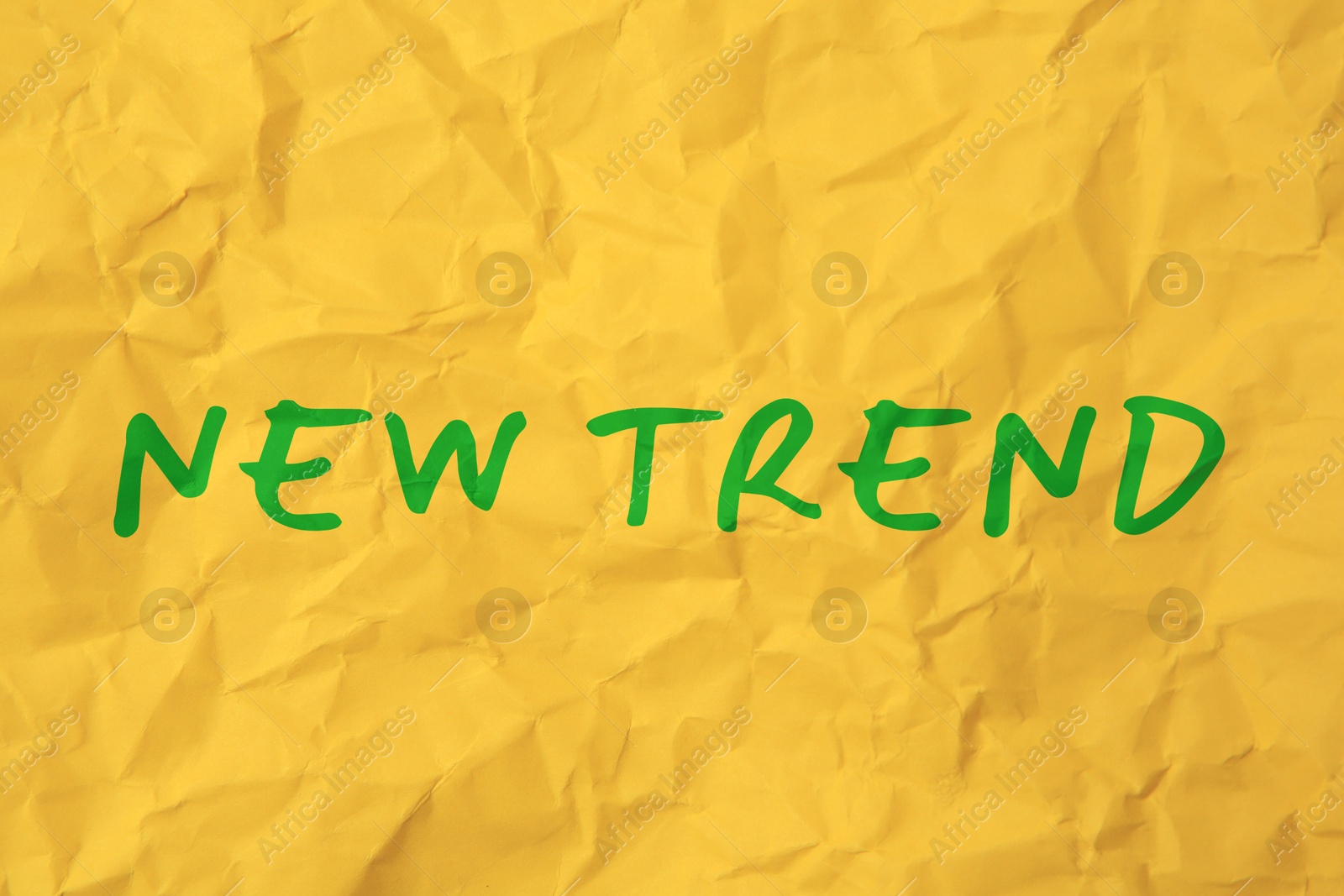 New Trend. Words on crumpled yellow sheet of paper Image of New Trend. Words on crumpled yellow sheet of paper