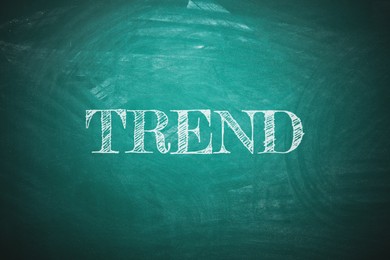 Image of Trend concept. White word on green chalkboard