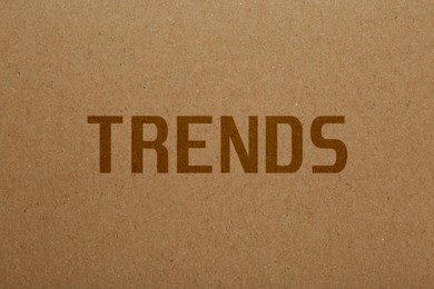 Image of Trends. Word on pale brown textured background