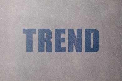 Image of Trend. Blue word on grey textured background