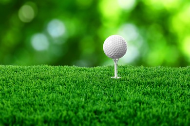Image of Golf ball on green grass outdoors, closeup