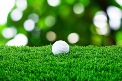 Image of Golf ball on green grass outdoors, closeup