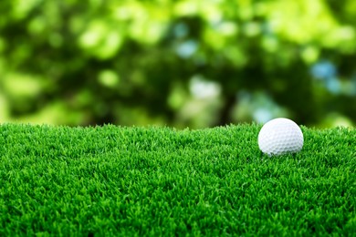 Image of Golf ball on green grass outdoors, closeup