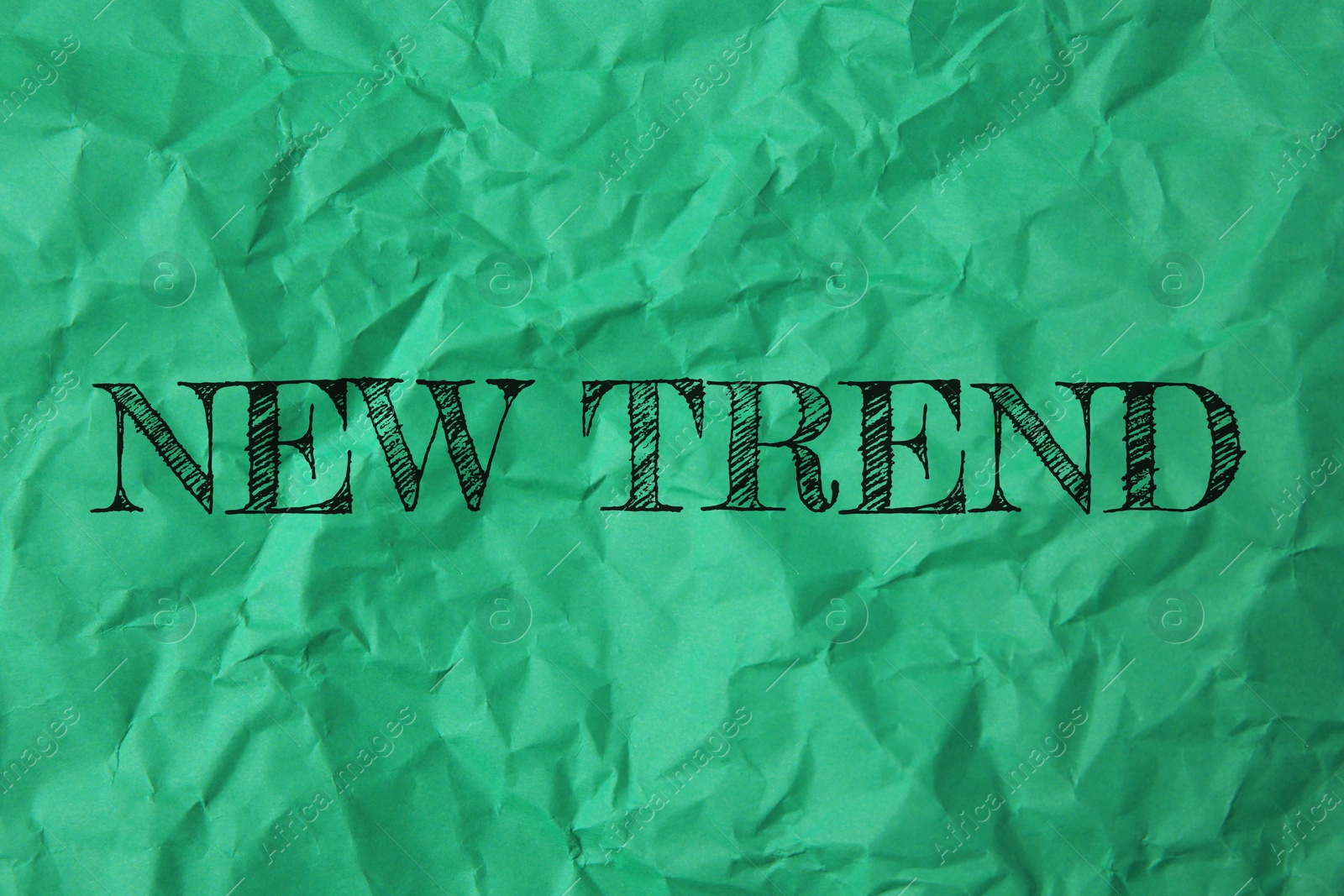New Trend. Words on crumpled green sheet of paper Image of New Trend. Words on crumpled green sheet of paper