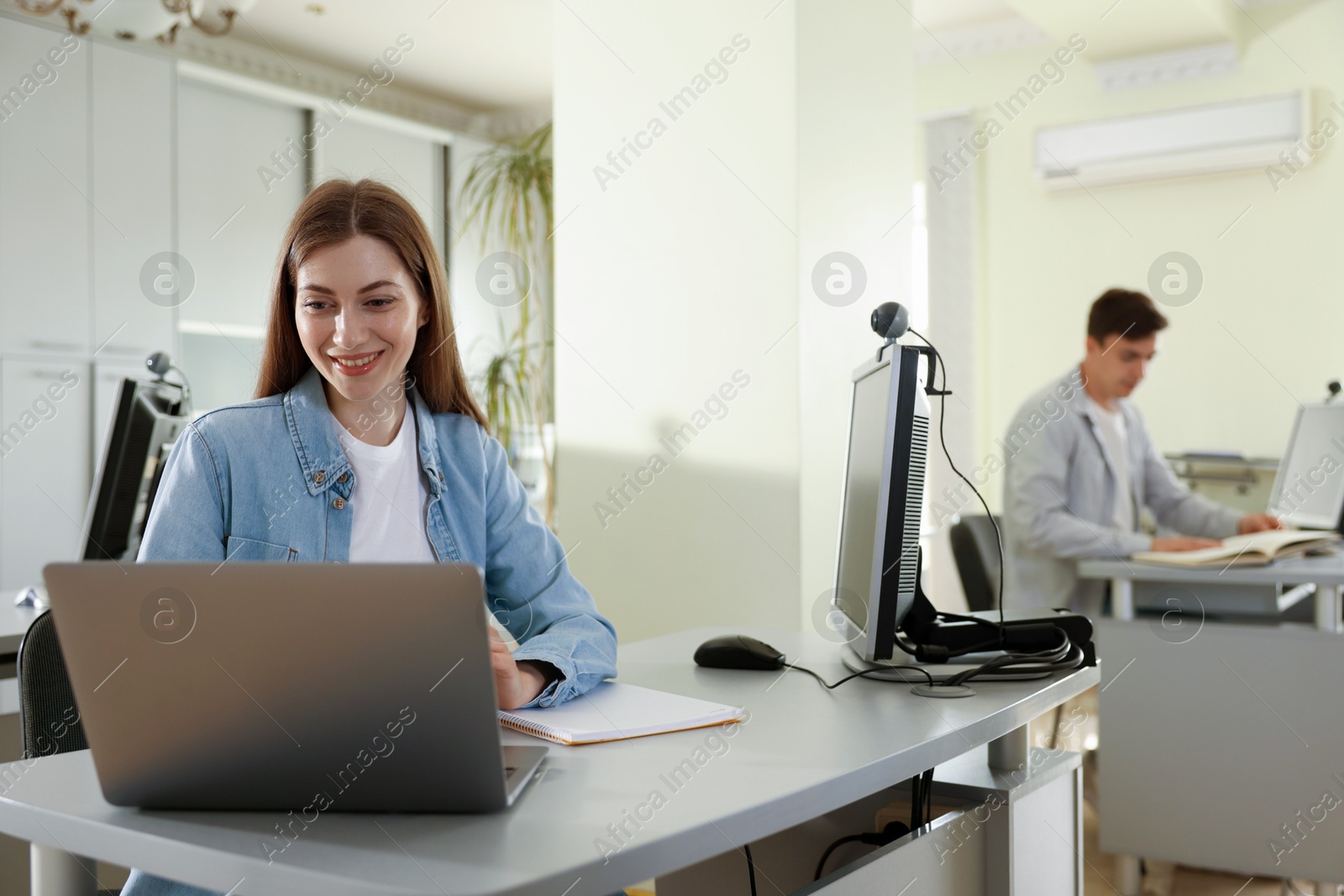 People working at desks in library, selective focus Photo of People working at desks in library, selective focus