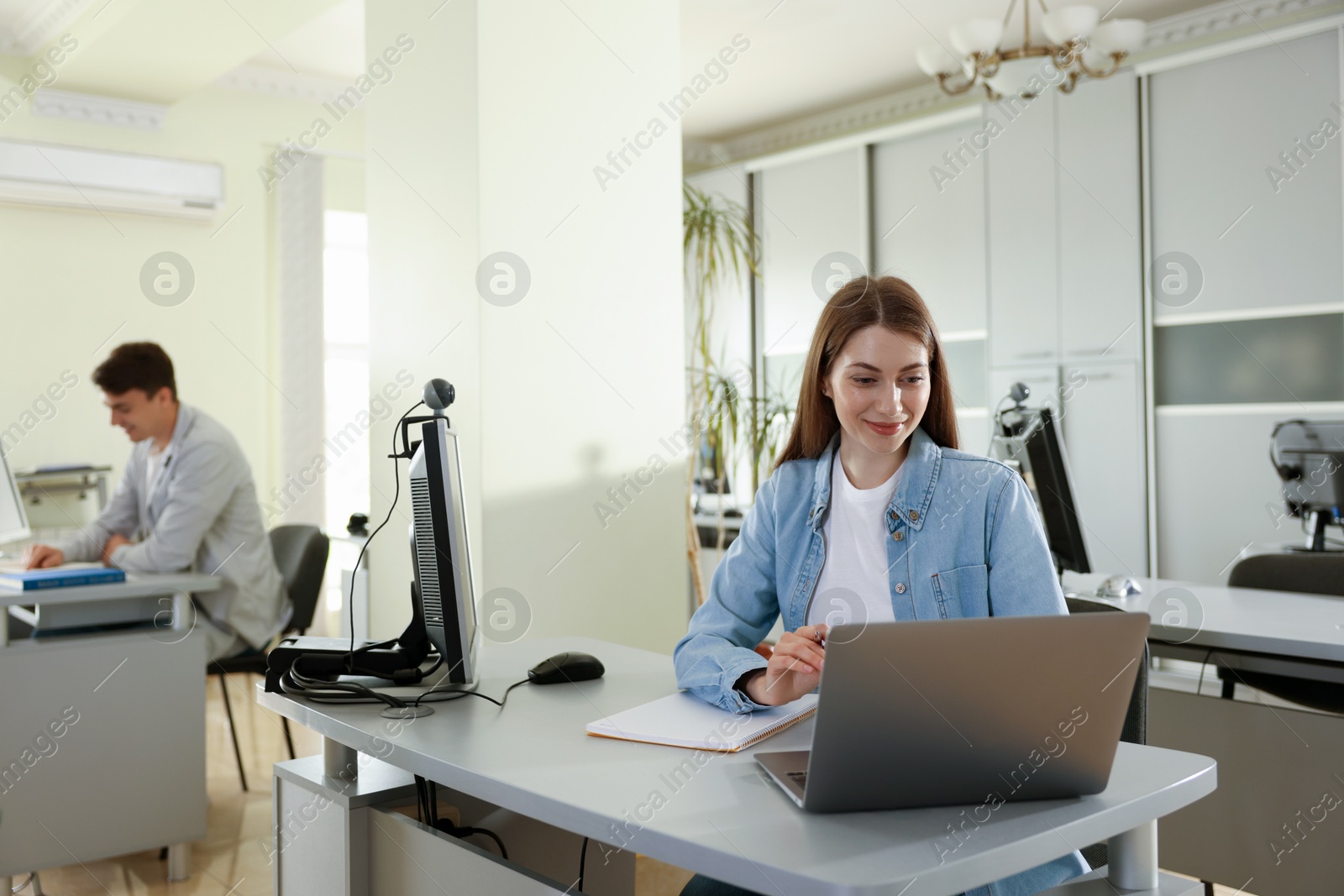 People working at desks in library, selective focus Photo of People working at desks in library, selective focus