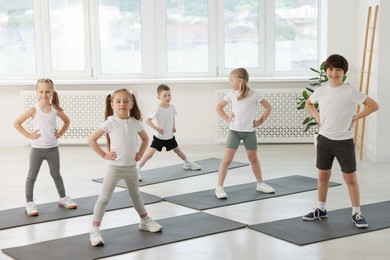 Photo of Group of children on yoga mats in class