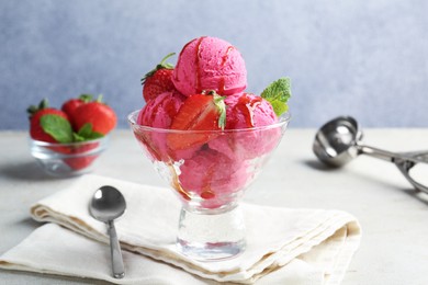 Photo of Tasty sorbet with strawberries and mint served on light table