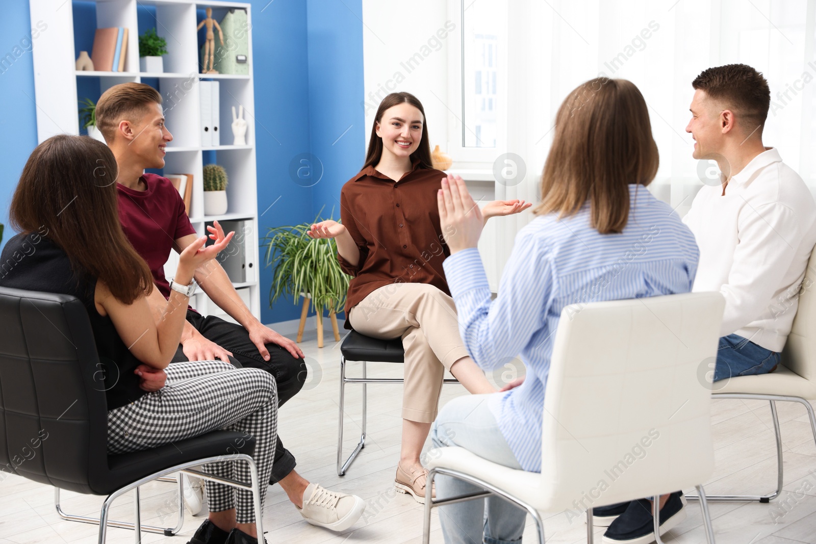 Photo of Group of people having meeting during life coaching class indoors