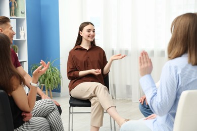 Photo of Group of people having meeting during life coaching class indoors
