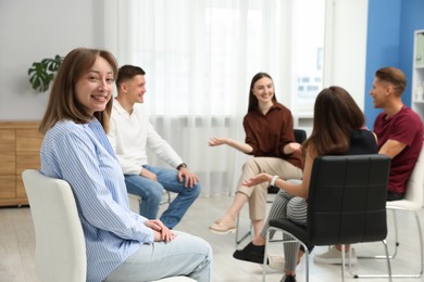 Photo of Group of people having meeting during life coaching class indoors, selective focus